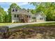 Charming gray home featuring a covered porch and well-maintained landscaping at 35 Fire Tower Dr, Rougemont, NC 27572