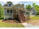 Charming two-story home with a covered front porch, wood stairs, and a landscaped yard at 35 Fire Tower Dr, Rougemont, NC 27572