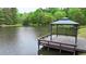 Lakeside gazebo on a wooden platform offers a tranquil escape at 35 Fire Tower Dr, Rougemont, NC 27572
