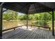 View from inside the gazebo overlooking the tranquil lake and lush greenery at 35 Fire Tower Dr, Rougemont, NC 27572