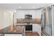 Well-equipped kitchen with modern white cabinets, stainless steel appliances, and an island with a gorgeous wood countertop at 35 Fire Tower Dr, Rougemont, NC 27572