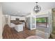 Bright and airy kitchen featuring white cabinetry, stainless appliances, and an island, flowing onto a back deck at 35 Fire Tower Dr, Rougemont, NC 27572
