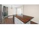 Modern kitchen island with a dark wood countertop, complemented by stainless steel appliances and abundant natural light at 35 Fire Tower Dr, Rougemont, NC 27572