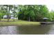 Picturesque lake view with home and gazebo surrounded by lush greenery at 35 Fire Tower Dr, Rougemont, NC 27572