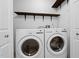 Functional laundry room features LG washer and dryer with overhead shelving and white trim at 35 Fire Tower Dr, Rougemont, NC 27572