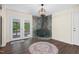 Cozy living room featuring a stone fireplace with a wood-burning stove, hardwood floors, and access to the deck at 35 Fire Tower Dr, Rougemont, NC 27572
