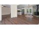 Open-concept living and kitchen area with hardwood floors, stainless steel appliances, and a wood-burning stove at 35 Fire Tower Dr, Rougemont, NC 27572