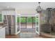 Modern kitchen connected to the living room with stainless steel refrigerator, a wood stove, and deck access at 35 Fire Tower Dr, Rougemont, NC 27572