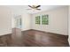 Inviting living room with wood floors, a ceiling fan, and large windows, offering plenty of natural light at 35 Fire Tower Dr, Rougemont, NC 27572