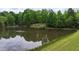Scenic pond with a cozy gazebo nestled among the lush, green trees at 35 Fire Tower Dr, Rougemont, NC 27572