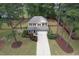 Aerial view of a two-story house with a manicured lawn, driveway, and surrounding trees at 35 Pine Water Way, Spring Lake, NC 28390