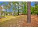 Large grassy backyard featuring mature trees and partial fencing at 35 Pine Water Way, Spring Lake, NC 28390