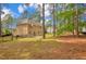 Large backyard featuring grass, mature trees, and a black fence at 35 Pine Water Way, Spring Lake, NC 28390