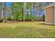 Spacious backyard with green grass and mature trees, providing shade and privacy at 35 Pine Water Way, Spring Lake, NC 28390
