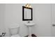 Clean, well-lit bathroom with a pedestal sink, toilet, and neutral decor for a serene feel at 35 Pine Water Way, Spring Lake, NC 28390
