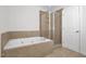 A spa-like bathroom with a large tub and walk-in shower at 35 Pine Water Way, Spring Lake, NC 28390