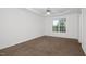 This bedroom has plush carpet, a ceiling fan, trey ceilings, and a big window at 35 Pine Water Way, Spring Lake, NC 28390