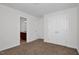 Bright bedroom featuring neutral carpet and paint, with an ensuite bathroom and closet at 35 Pine Water Way, Spring Lake, NC 28390