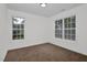 Bedroom with plush carpet, white trim, and many windows allowing for abundant natural light at 35 Pine Water Way, Spring Lake, NC 28390