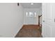 Bright, neutral foyer with hardwood floors transitioning to carpet, leading to a white front door at 35 Pine Water Way, Spring Lake, NC 28390