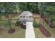 Aerial view of a home with a manicured lawn, lush landscaping, and a two-car garage at 35 Pine Water Way, Spring Lake, NC 28390