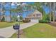 Charming two-story home with a well-manicured lawn and a long driveway leading to an attached two-car garage at 35 Pine Water Way, Spring Lake, NC 28390