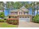 Charming home with a stone and siding exterior, red shutters, and a two-car garage at 35 Pine Water Way, Spring Lake, NC 28390