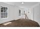 Bright upstairs hallway with two windows, chandelier and wooden staircase at 35 Pine Water Way, Spring Lake, NC 28390