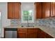 Modern kitchen featuring granite countertops, stainless steel appliances, tile backsplash, and wood cabinets at 35 Pine Water Way, Spring Lake, NC 28390