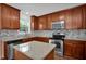 Bright kitchen with stainless steel appliances, granite countertops, and an island, perfect for cooking at 35 Pine Water Way, Spring Lake, NC 28390
