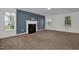 Bright living room with a modern fireplace, neutral walls, and large windows at 35 Pine Water Way, Spring Lake, NC 28390