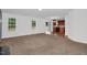 Bright living room with plush carpeting, natural light from windows, and an open floorplan that leads into the kitchen at 35 Pine Water Way, Spring Lake, NC 28390