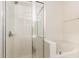 Bathroom with a glass enclosed shower, soaking tub, and white tiled walls at 4002 Cherry Blossom Cir, Durham, NC 27713