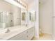Well-lit bathroom with double sink vanity, large mirror and a glass-enclosed shower at 4002 Cherry Blossom Cir, Durham, NC 27713