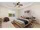 A staged bedroom that features a neutral color palette, a tray ceiling, and large windows at 4002 Cherry Blossom Cir, Durham, NC 27713