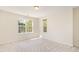 Neutral bedroom with carpeted floors and large windows overlooking the backyard at 4002 Cherry Blossom Cir, Durham, NC 27713