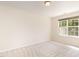 Bright bedroom with plush carpeting and a large window providing natural light at 4002 Cherry Blossom Cir, Durham, NC 27713