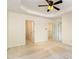 Spacious bedroom with neutral carpet, tray ceiling and multiple closets at 4002 Cherry Blossom Cir, Durham, NC 27713