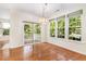 Dining area with hardwood floors, chandelier, and sliding glass doors to the balcony at 4002 Cherry Blossom Cir, Durham, NC 27713