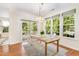 Bright dining room with hardwood floors, chandelier, and access to outdoor balcony at 4002 Cherry Blossom Cir, Durham, NC 27713