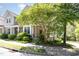 Inviting front of home features mature tree offering shade and curb appeal at 4002 Cherry Blossom Cir, Durham, NC 27713