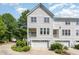 Charming townhome with white siding, multiple windows, and attached garages, set amidst green landscaping at 4002 Cherry Blossom Cir, Durham, NC 27713
