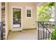 Cozy covered front porch with black railings and ample space for relaxing at 4002 Cherry Blossom Cir, Durham, NC 27713