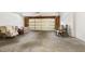 Spacious garage with a light-colored door, offering ample space for parking and storage with exposed walls and ceiling at 4002 Cherry Blossom Cir, Durham, NC 27713