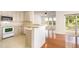 Open kitchen featuring a breakfast bar and view into the living room at 4002 Cherry Blossom Cir, Durham, NC 27713