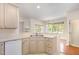 Kitchen featuring tile countertops, stainless steel sink, and view into the dining room at 4002 Cherry Blossom Cir, Durham, NC 27713