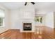 Living room featuring hardwood floors, fireplace, and view into the dining area at 4002 Cherry Blossom Cir, Durham, NC 27713