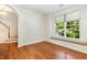 Cozy living room with hardwood floors and a large window with a window seat at 4002 Cherry Blossom Cir, Durham, NC 27713