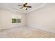 Spacious main bedroom featuring a tray ceiling, large window, neutral carpeting, and ample natural light at 4002 Cherry Blossom Cir, Durham, NC 27713