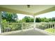 Covered balcony with white railings and views of lush green trees at 4024 Claret Ln, Morrisville, NC 27560